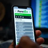 Mobile phone screen displaying Forebet USSD betting menu with Nigerian currency symbols